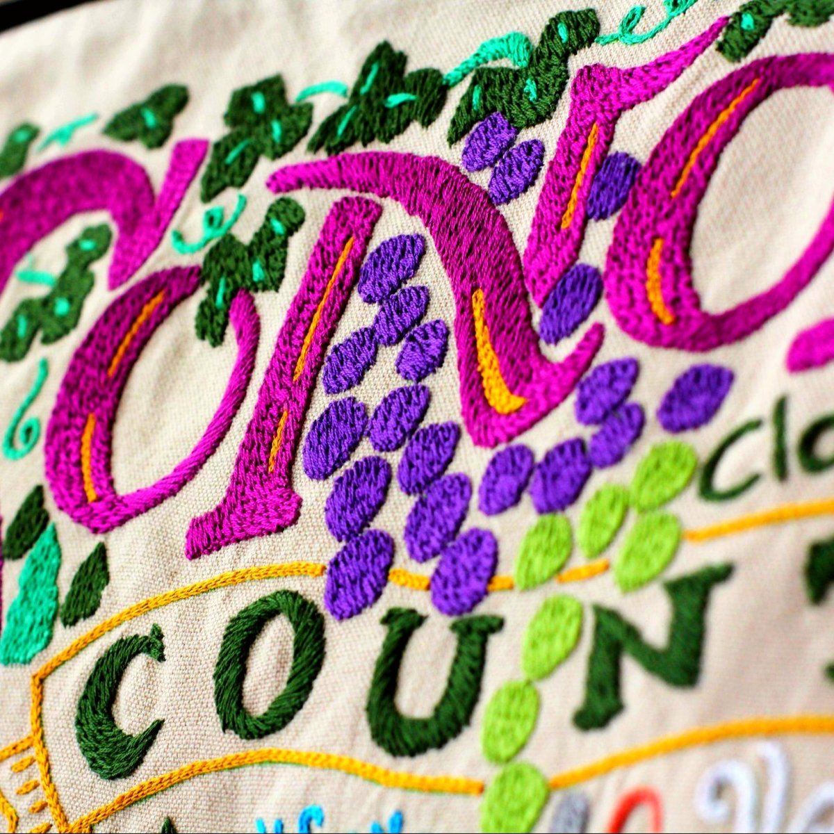 Sonoma County Wine Country Embroidered Travel Pillow - close-up detail of hand-embroidered needlepoint stitching