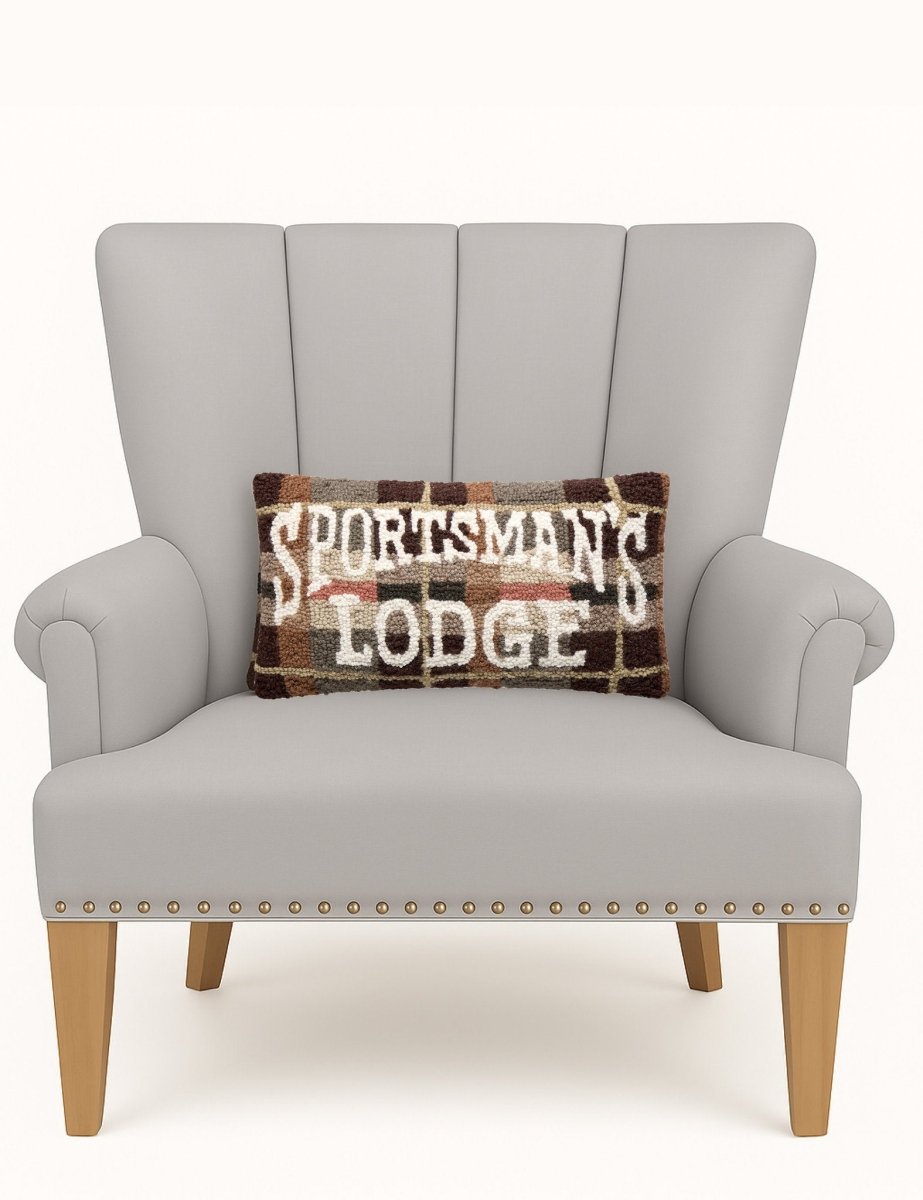 Sportsman's Lodge Hooked Wool Throw Pillow on an armchair, showing the throw pillow at room scale, 9x16 inch
