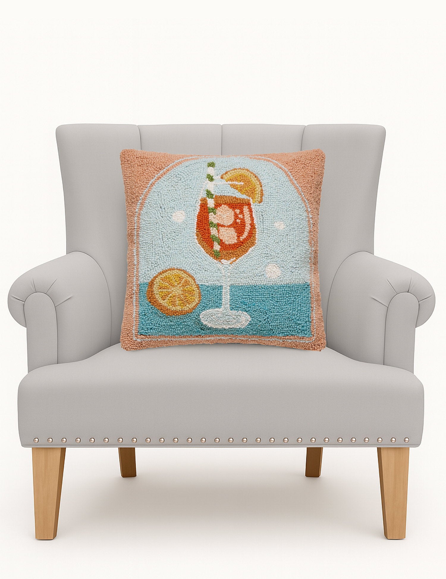 Spritz Hooked Wool Throw Pillow on an armchair, showing the throw pillow at room scale, 16x16 inch