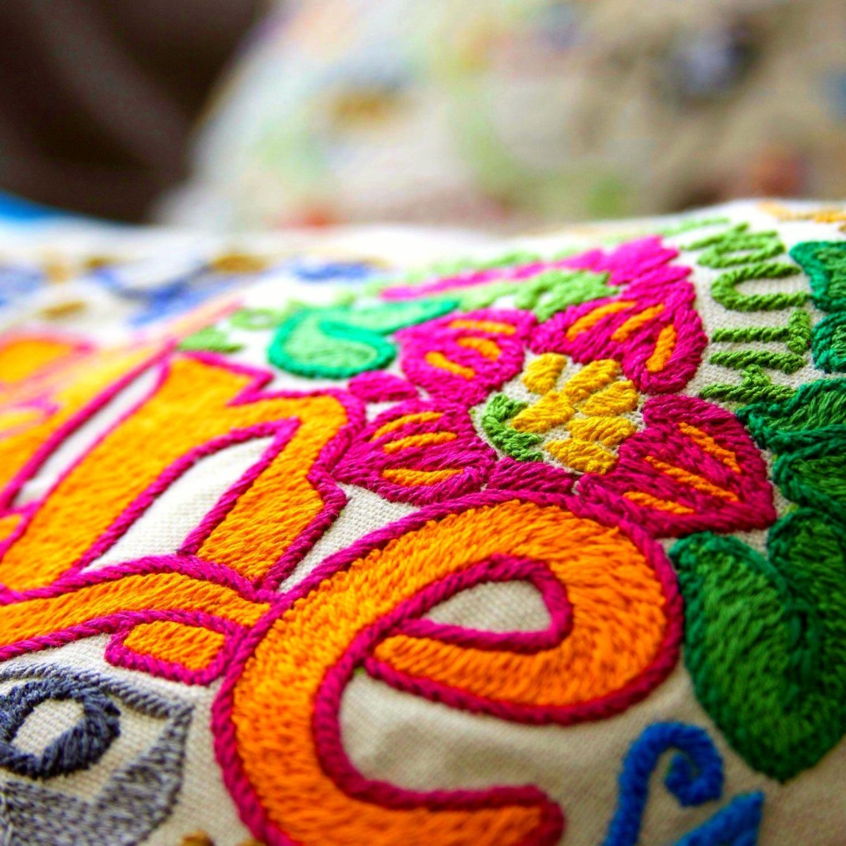 St. Augustine XL Embroidered Travel Throw Pillow - close-up detail of hand-embroidered needlepoint stitching