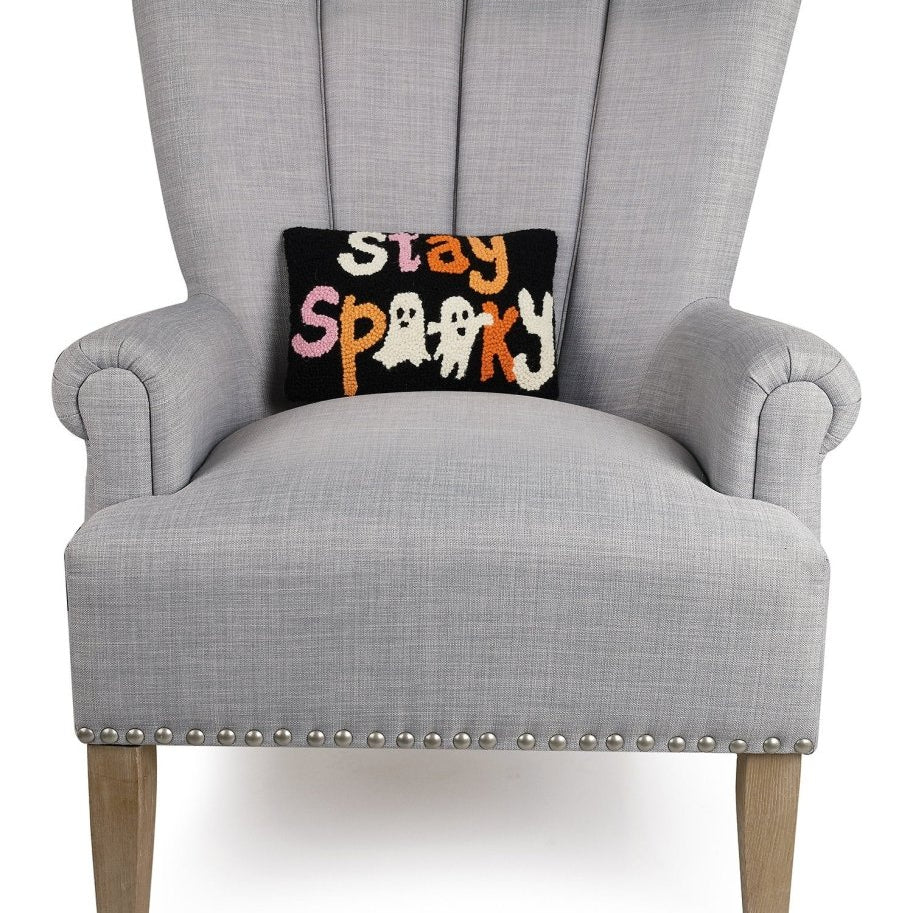 Stay Spooky Hooked Wool Halloween Throw Pillow on an armchair, showing the throw pillow at room scale, 8x12 inch