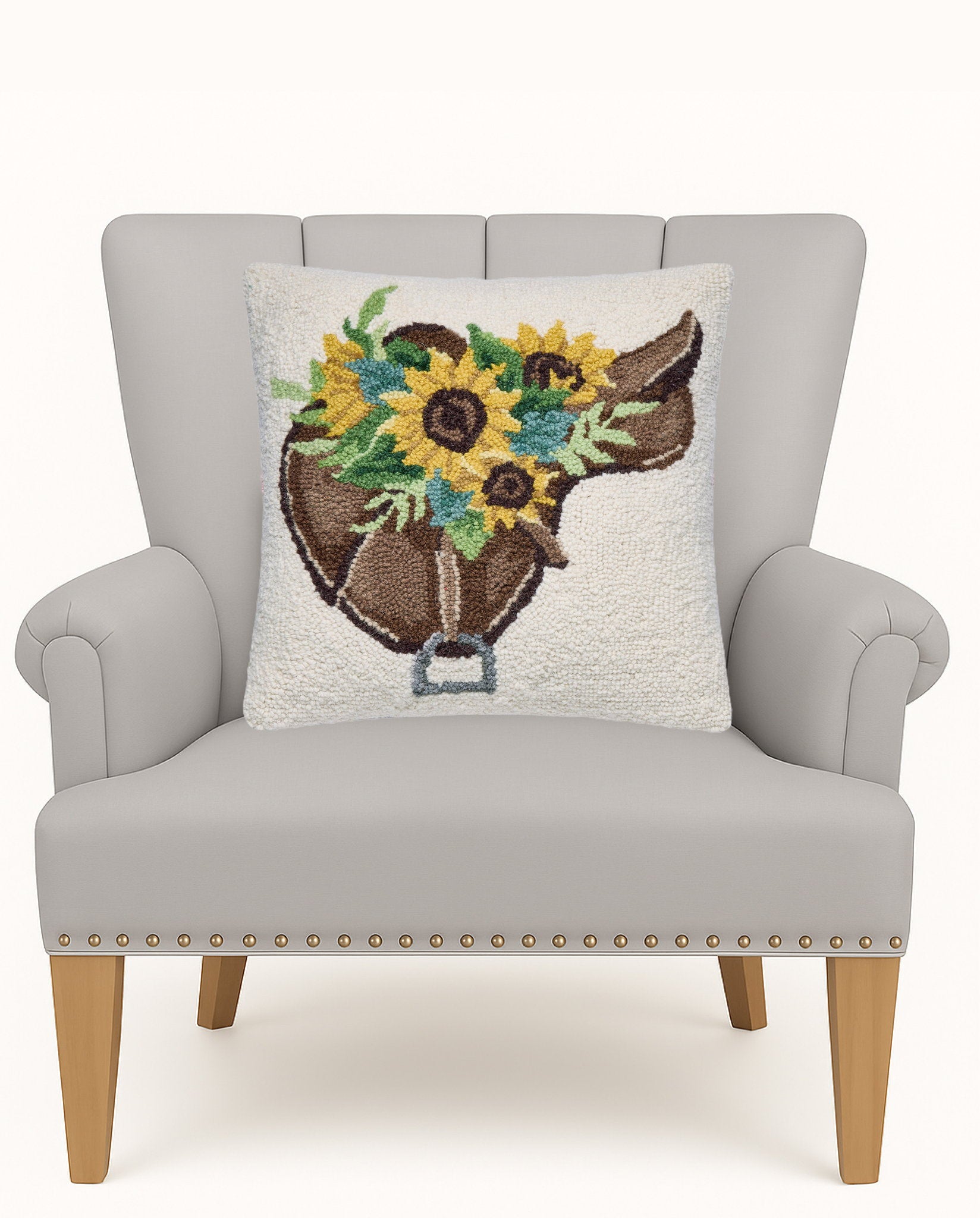 Sunflower Saddle Hooked Wool Throw Pillow on an armchair, showing the throw pillow at room scale, 16x16 inch