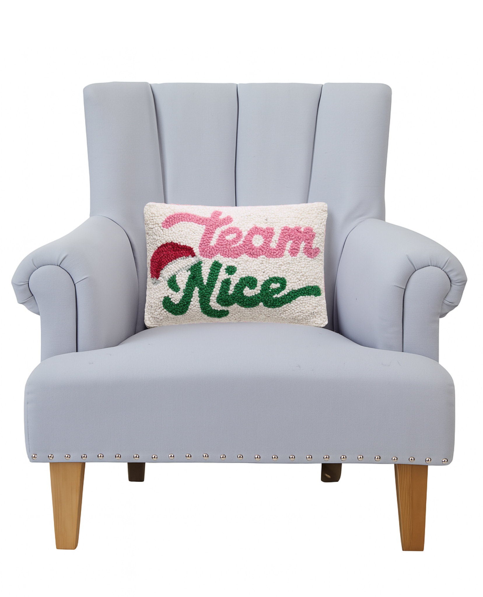 Team Nice Hooked Wool Christmas Throw Pillow on an armchair, showing the throw pillow at room scale, 8x12 inch