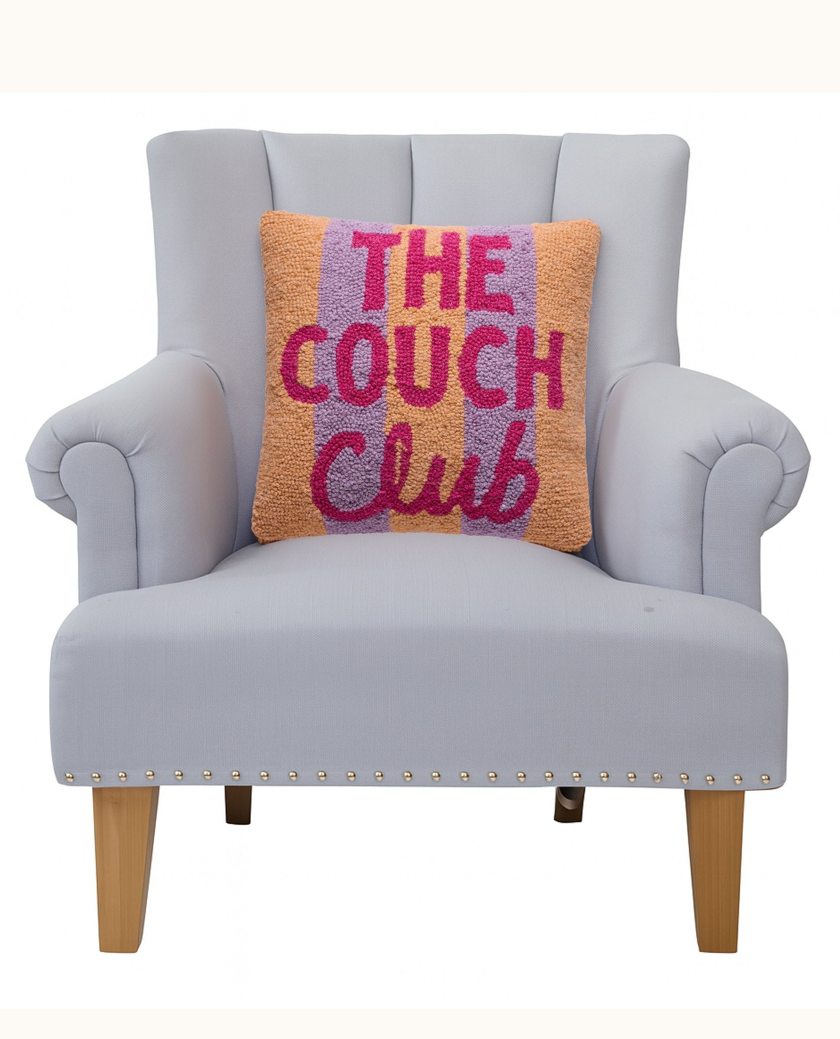 The Couch Club Hooked Wool Throw Pillow on an armchair, showing the throw pillow at room scale, 14x14 inch