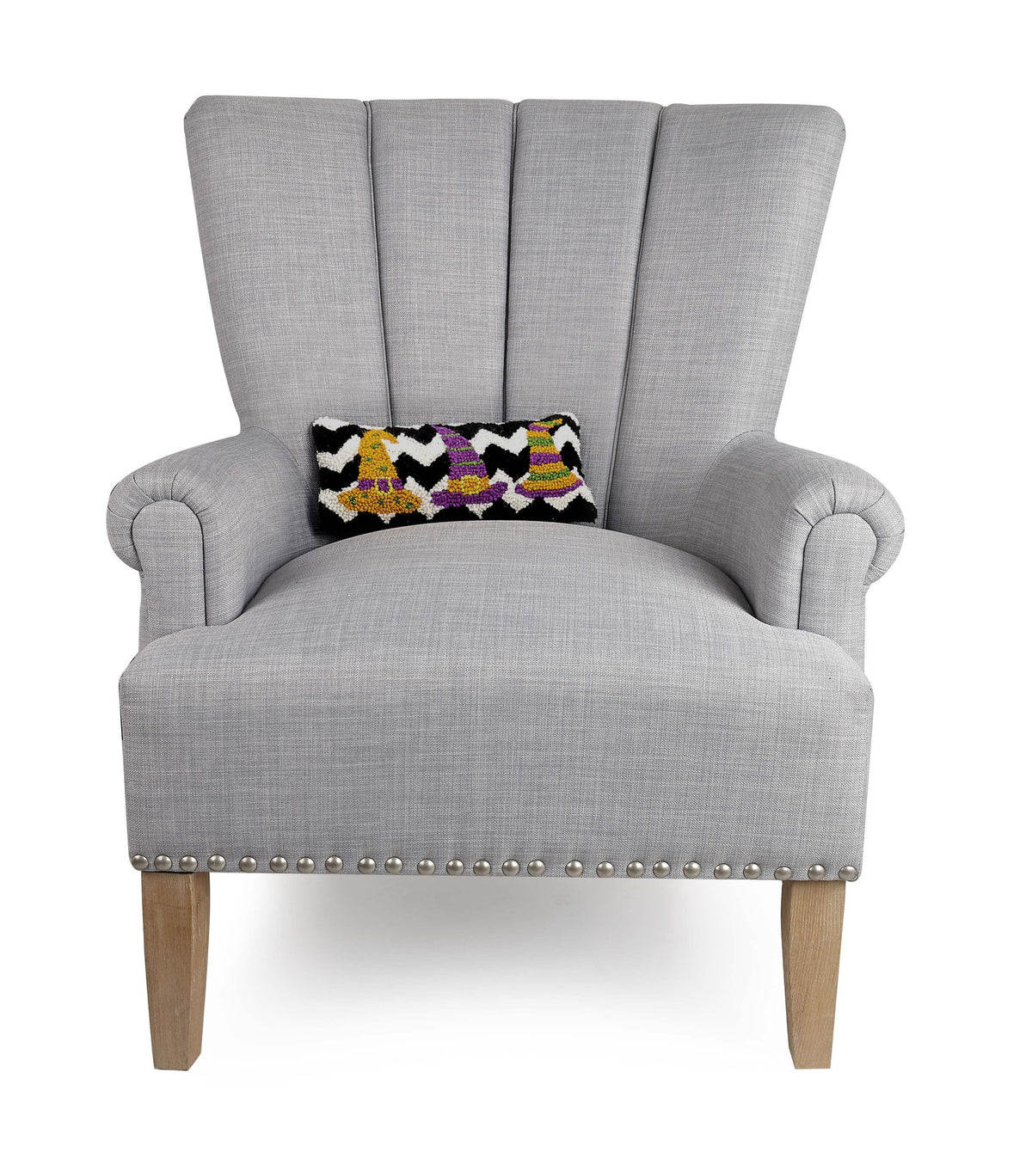 Three Striped Witch Hats Hooked Wool Halloween Throw Pillow on an armchair, showing the throw pillow at room scale, 12x5 inch
