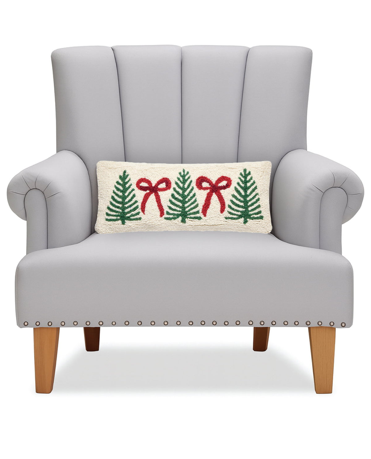 Tree Bow Hooked Wool Christmas Throw Pillow on an armchair, showing the throw pillow at room scale, 8x20 inch