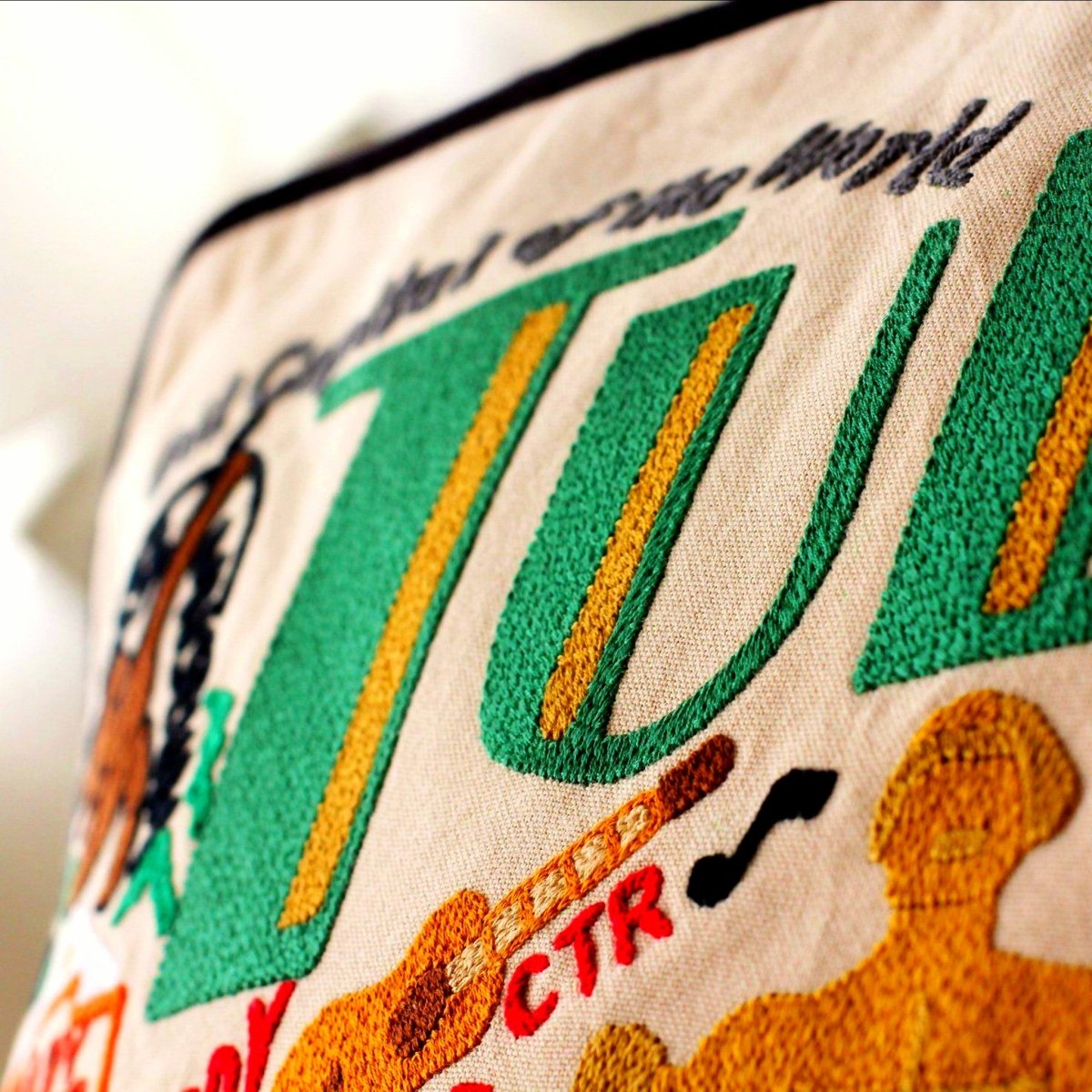 Tulsa, OK Oil City Embroidered Travel Throw Pillow - close-up detail of hand-embroidered needlepoint stitching