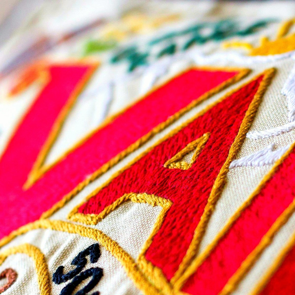 Vail, CO Embroidered Ski Lodge Pillow - close-up detail of hand-embroidered needlepoint stitching