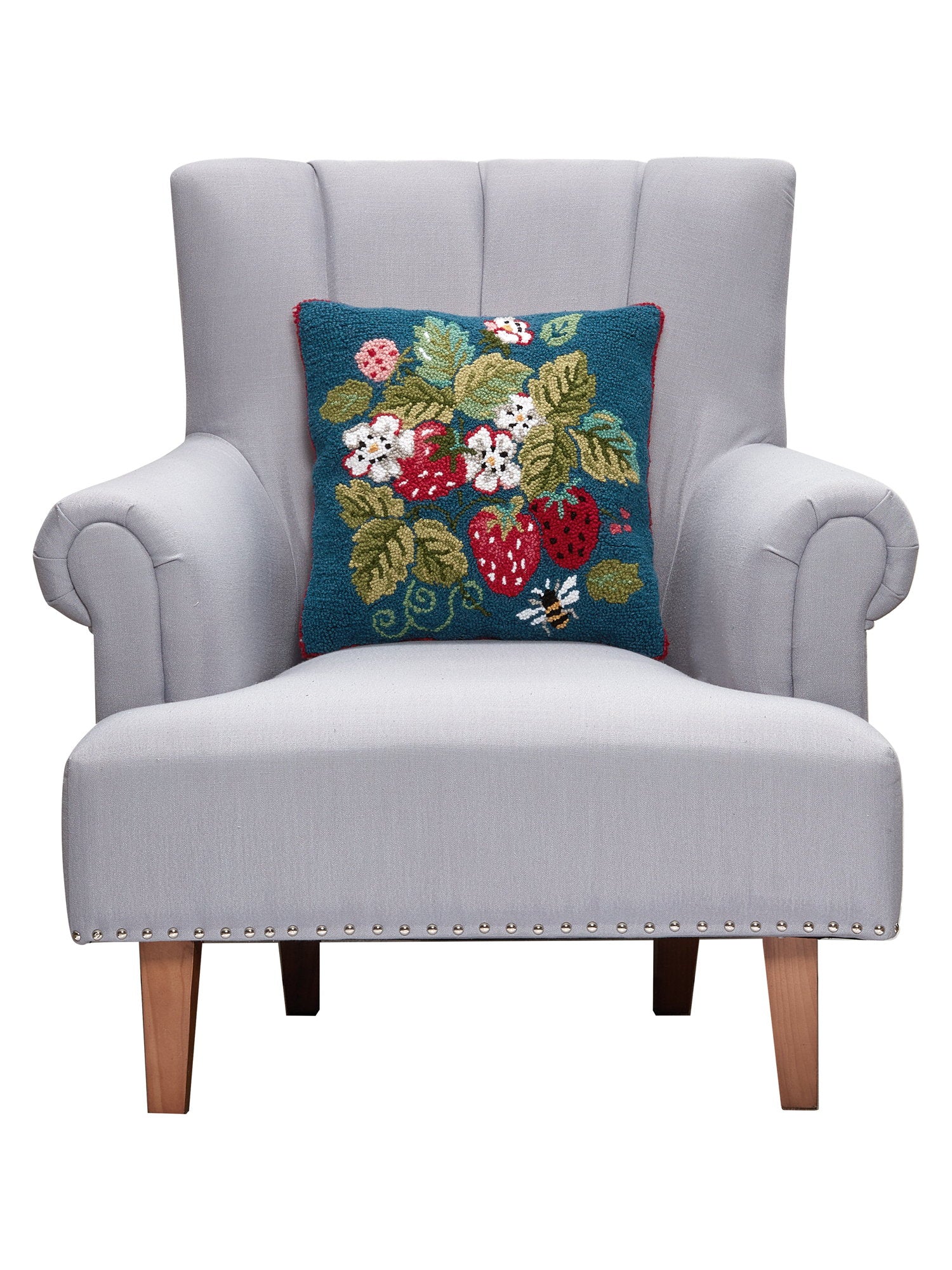 Vintage Strawberries Hooked Wool Throw Pillow on an armchair, showing the throw pillow at room scale, 16x16 inch