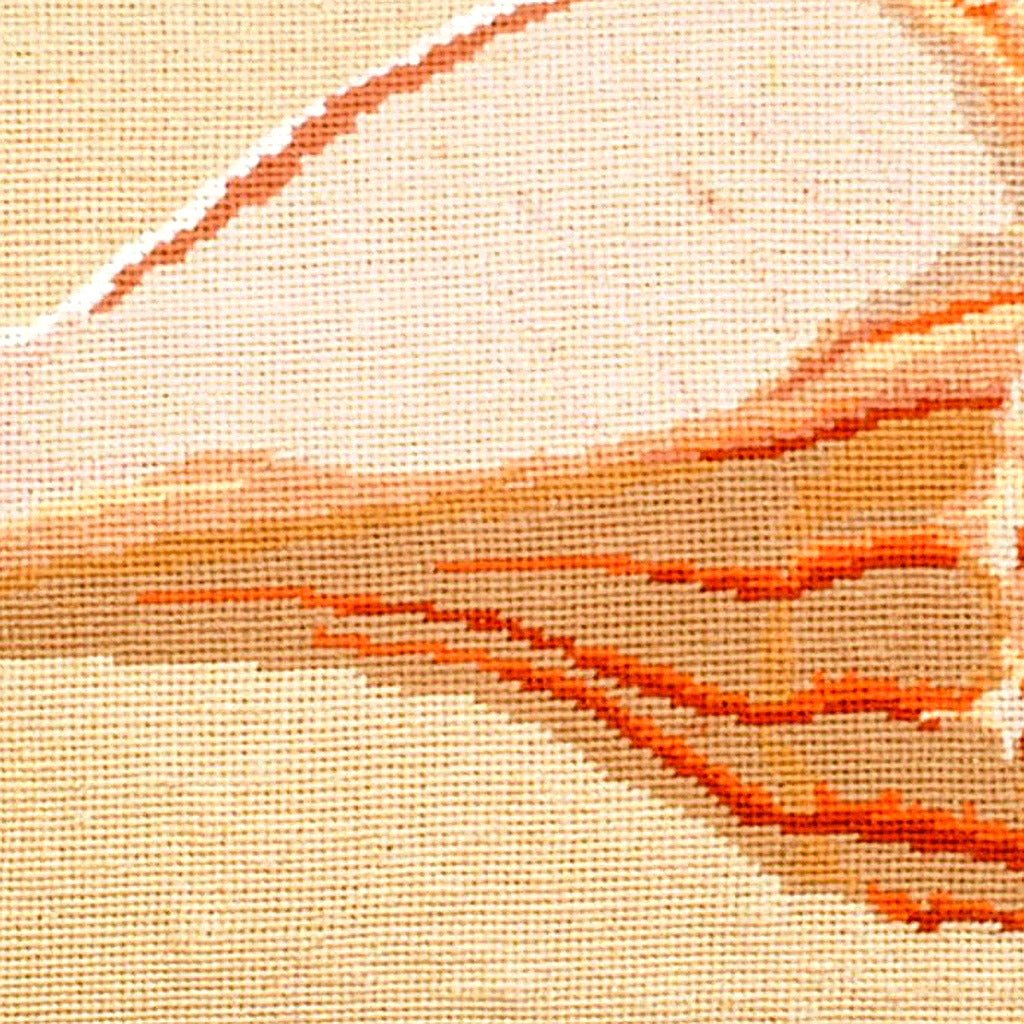 Hand-stitched wool detail of Whelk Shell Coastal needlepoint pillow showing intricate weave pattern and texture