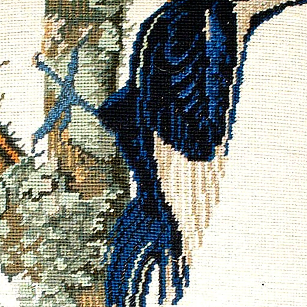 Hand-stitched wool detail of White Ivory Billed Woodpecker needlepoint pillow showing intricate weave pattern and texture