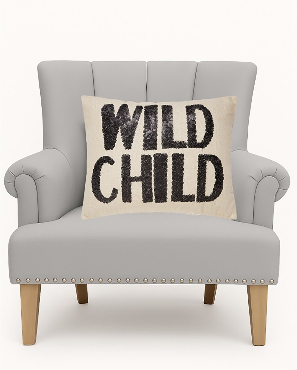 Wild Child Sequin Embroidered Throw Pillow on an armchair, showing the throw pillow at room scale, 14x18 inch