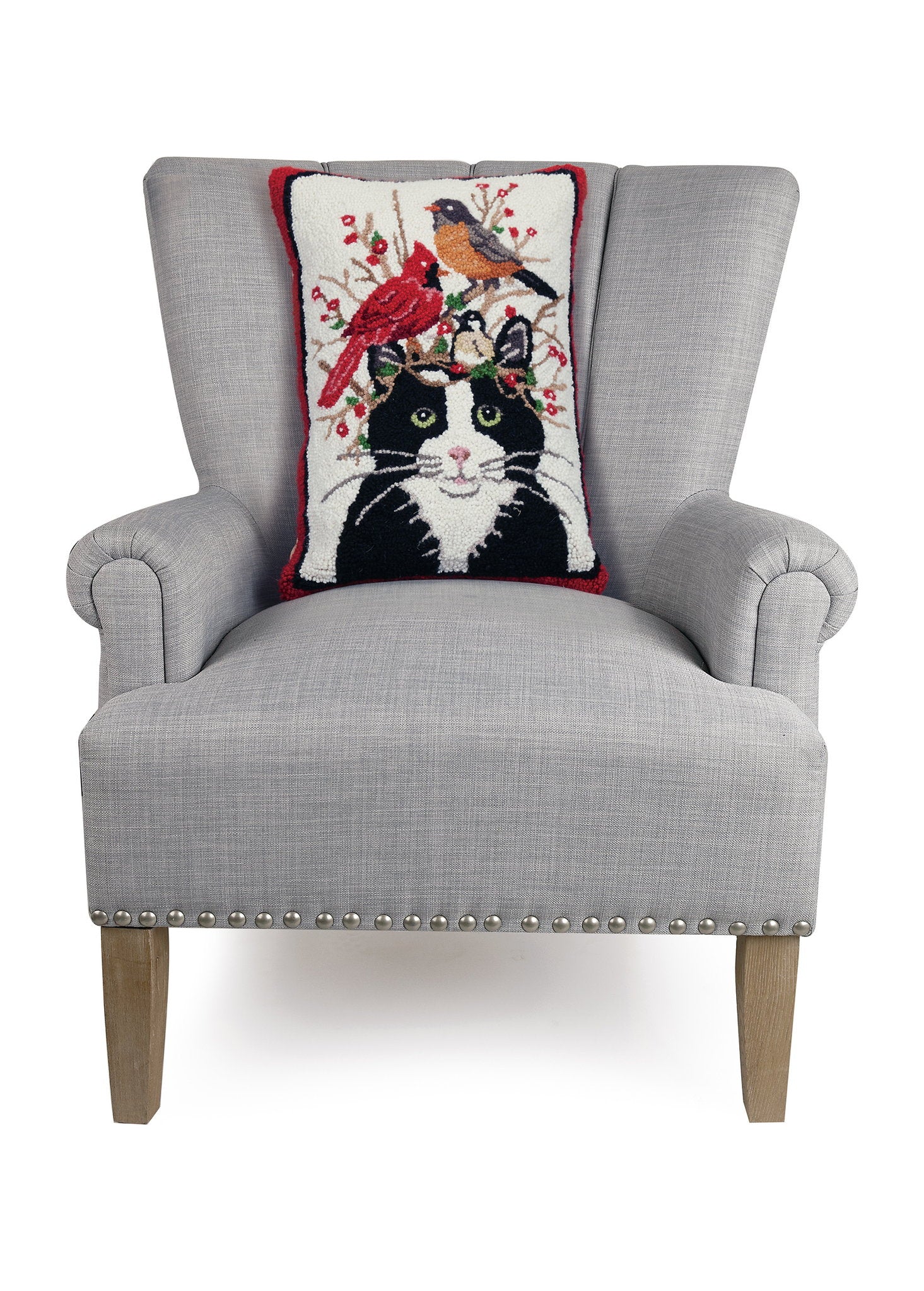 Winter Cat and Birds Hooked Wool Throw Pillow on an armchair, showing the throw pillow at room scale, 14x20 inch