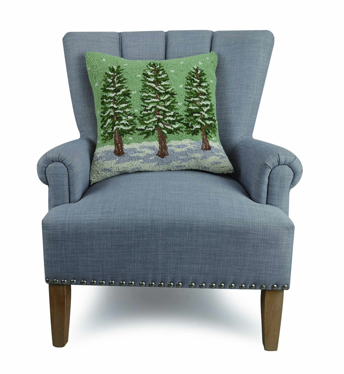 Winter Trees Hooked Wool Christmas Throw Pillow on an armchair, showing the throw pillow at room scale, 18x18 inch