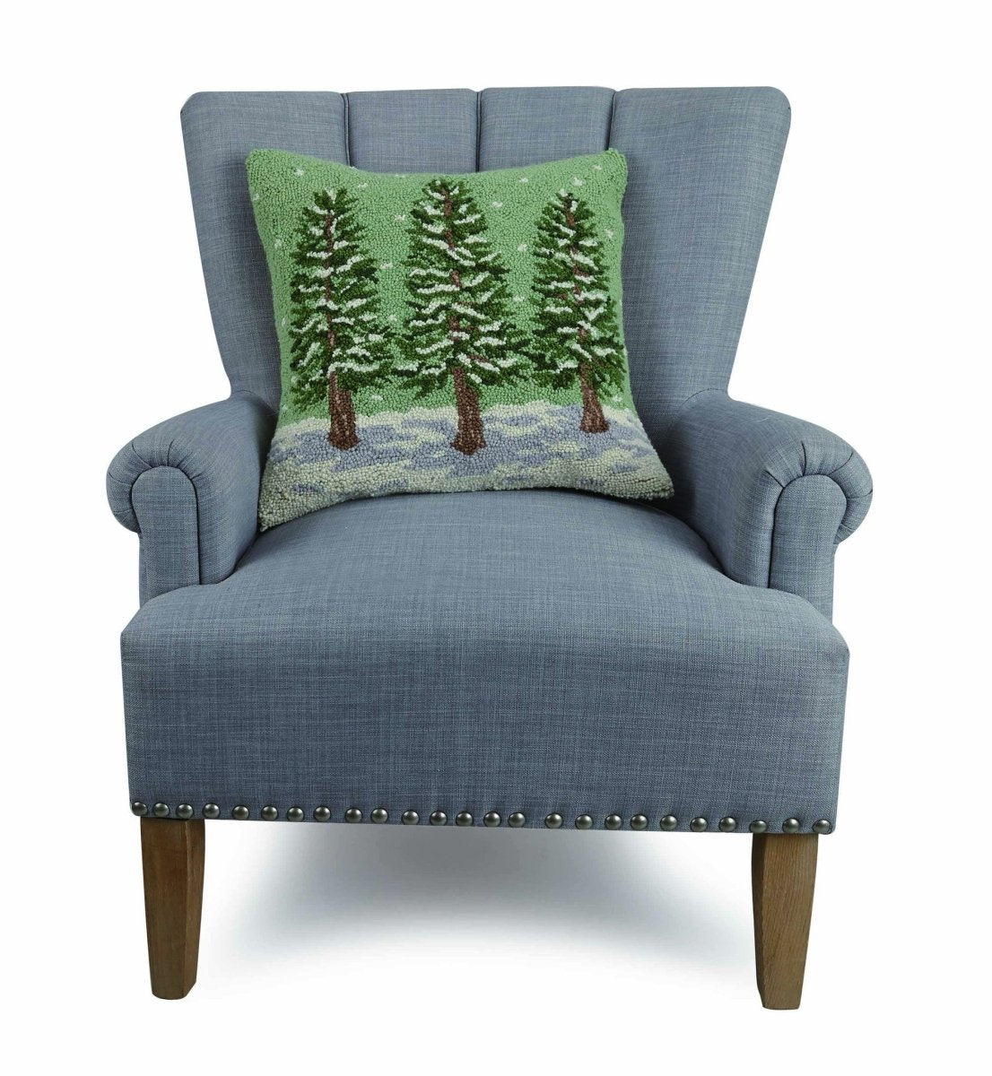 Winter Trees Hooked Wool Christmas Throw Pillow on an armchair, showing the throw pillow at room scale, 18x18 inch