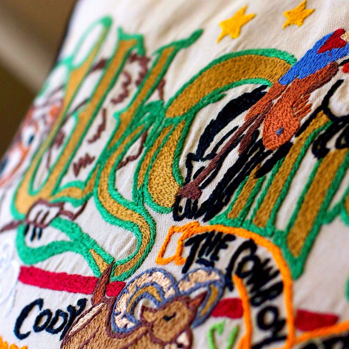Wyoming State Cowboy Travel Embroidered Throw Pillow - close-up detail of hand-embroidered needlepoint stitching