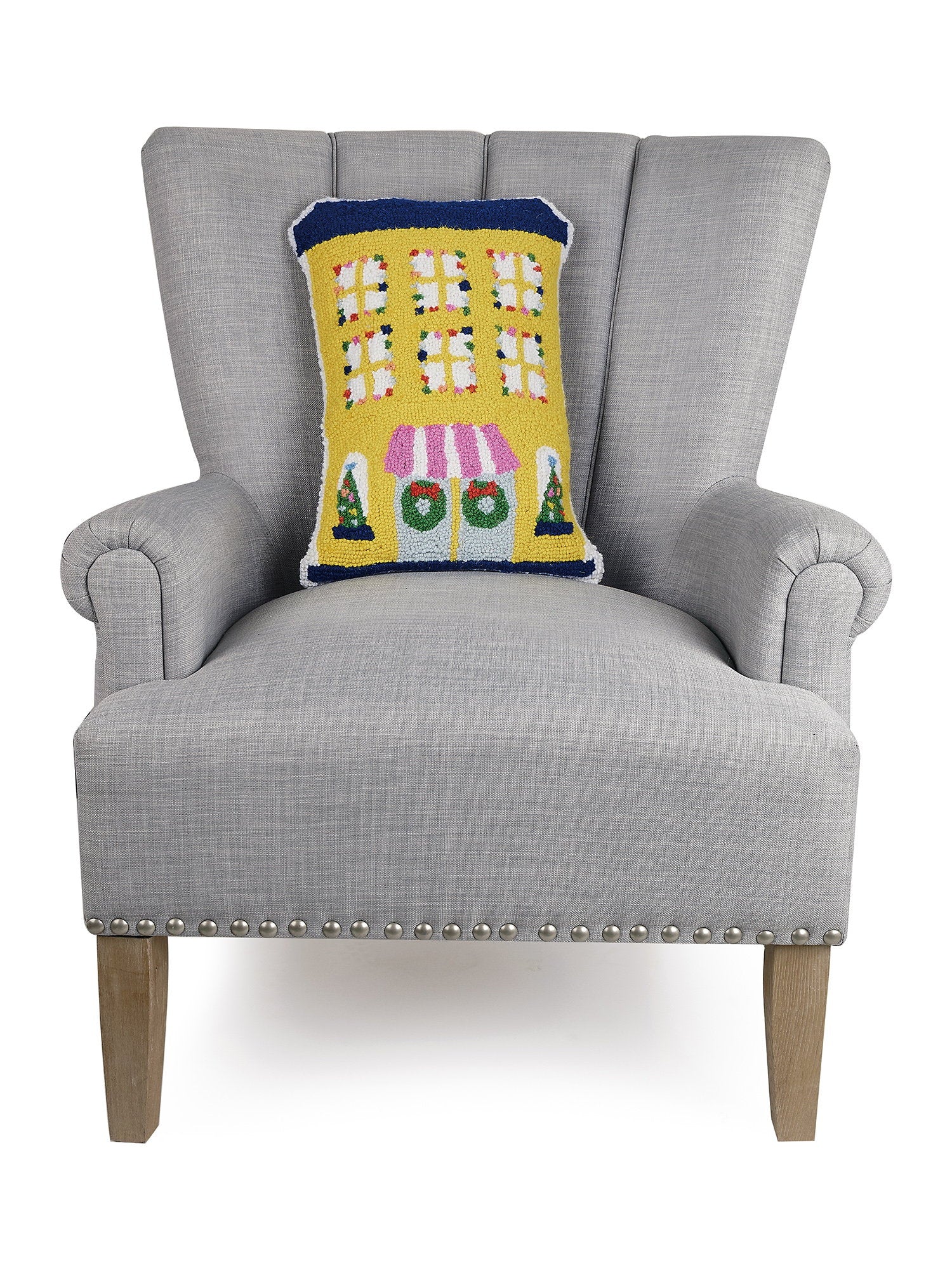 Yellow House Shaped Hooked Wool Christmas Throw Pillow on an armchair, showing the throw pillow at room scale, 12x18 inch