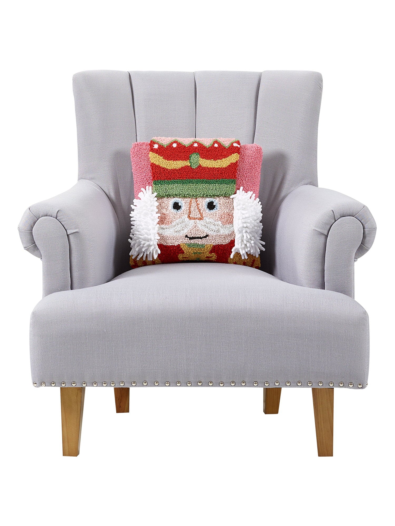3D Nutcracker Hooked Christmas Throw Pillow on an armchair, showing the throw pillow at room scale, 14x14 inch