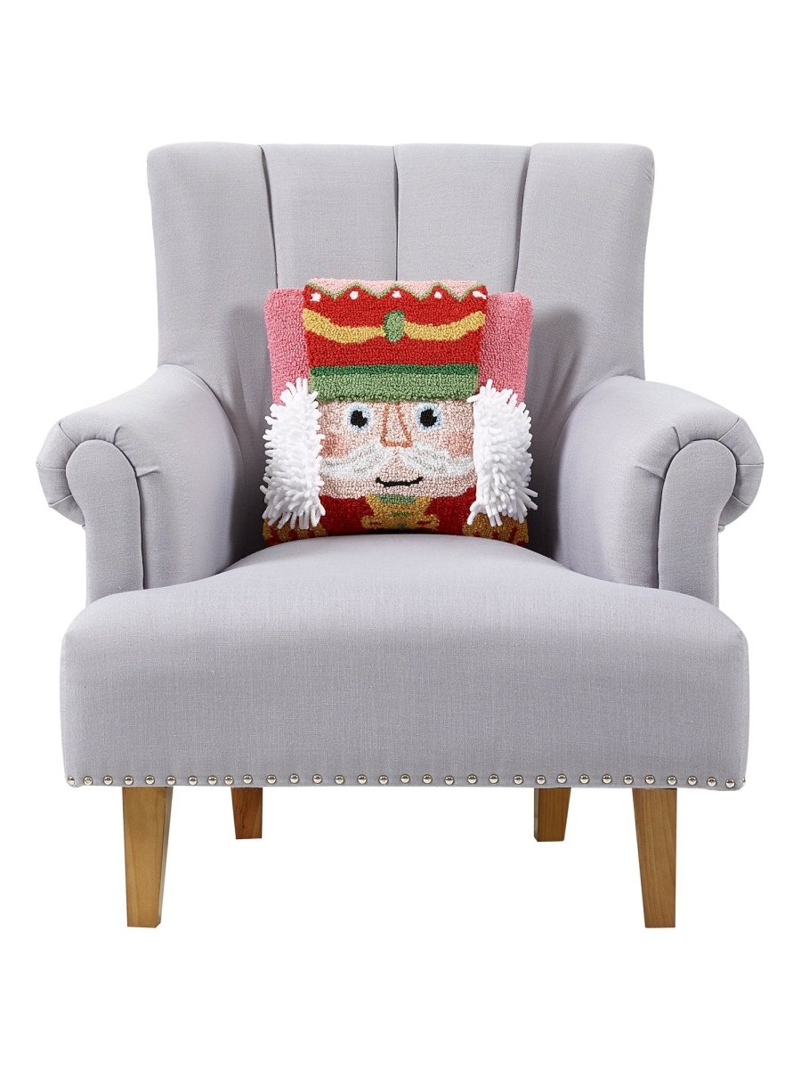 3D Nutcracker Hooked Christmas Throw Pillow on an armchair, showing the throw pillow at room scale, 14x14 inch