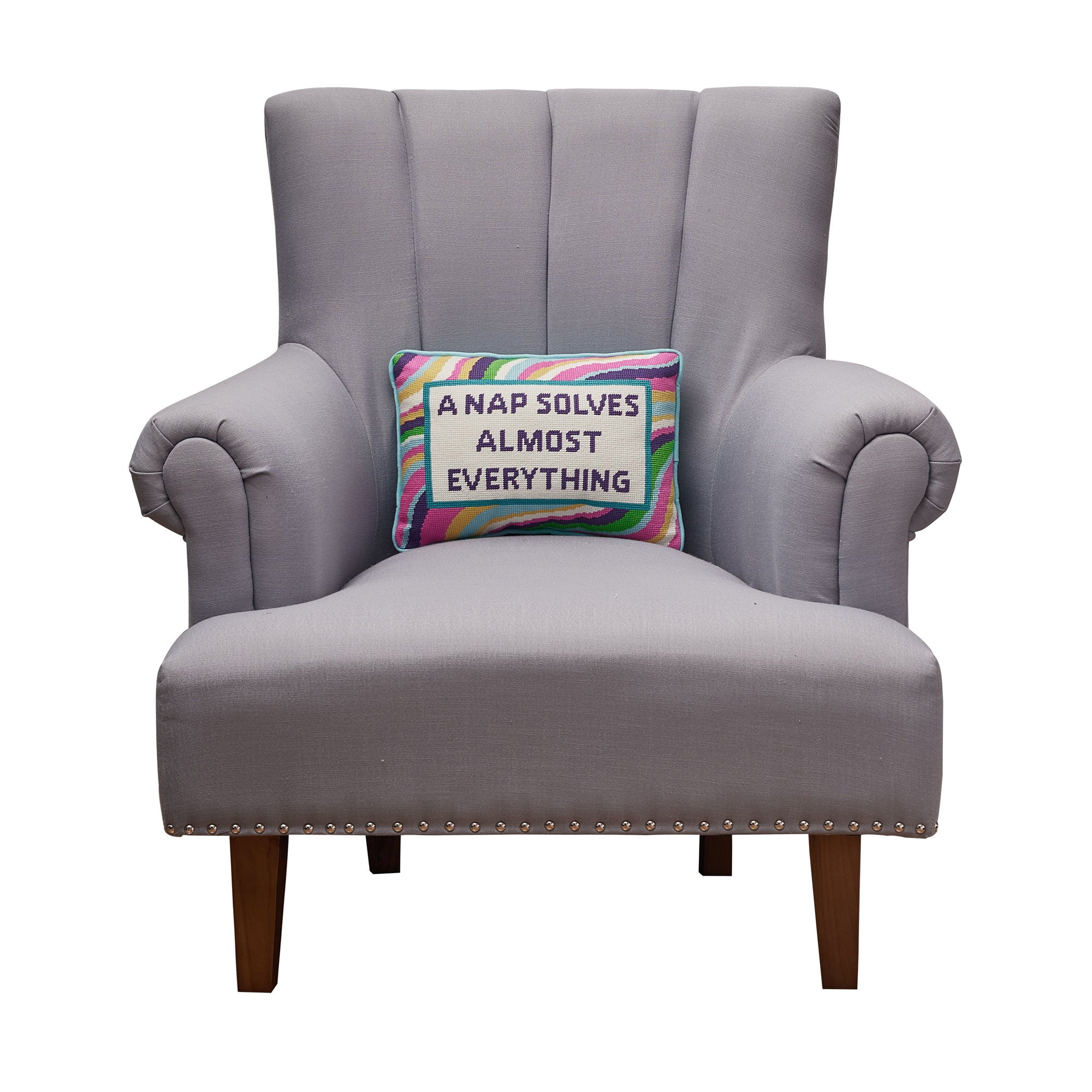 A Nap Solves Almost Embroidered Needlepoint Throw Pillow on an armchair, showing the throw pillow at room scale, 10x14 inch