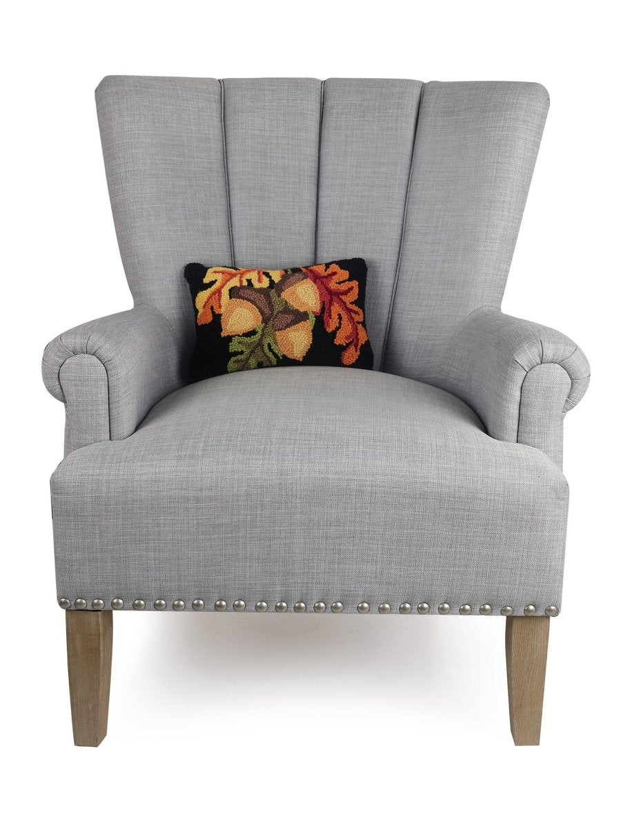 Acorn with Leaves Hooked Wool Fall Harvest Throw Pillow on an armchair, showing the throw pillow at room scale, 8x12 inch