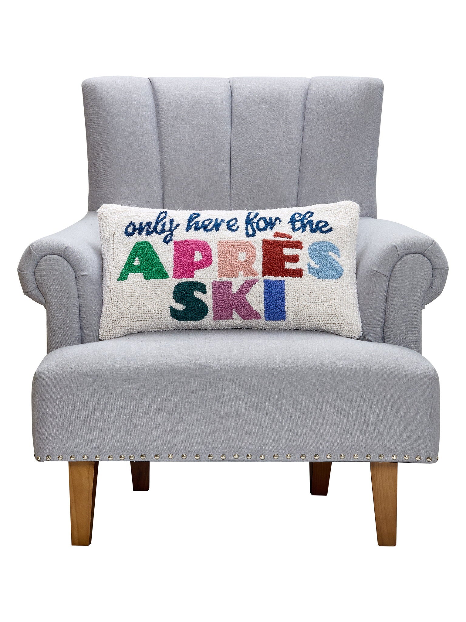 Après Ski Hooked Wool Christmas Throw Pillow on an armchair, showing the throw pillow at room scale, 12x22 inch