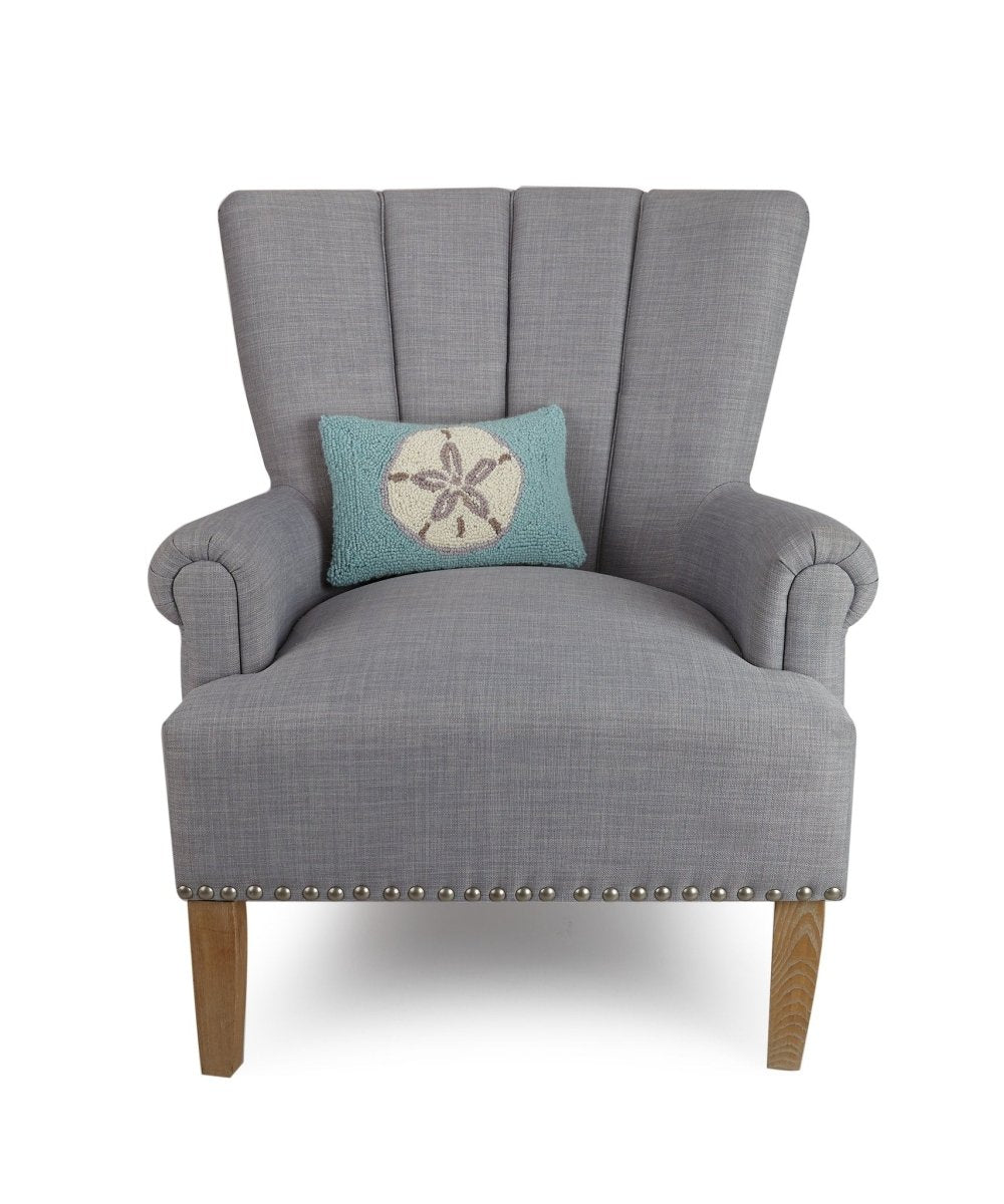 Aqua Ground Sand Dollar Hooked Wool Throw Pillow on an armchair, showing the throw pillow at room scale, 8x12 inch