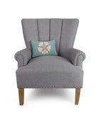 Aqua Ground Sand Dollar Hooked Wool Throw Pillow on an armchair, showing the throw pillow at room scale, 8x12 inch