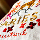 Aries Astrology Zodiac Embroidered Throw Pillow - close-up detail of hand-embroidered needlepoint stitching
