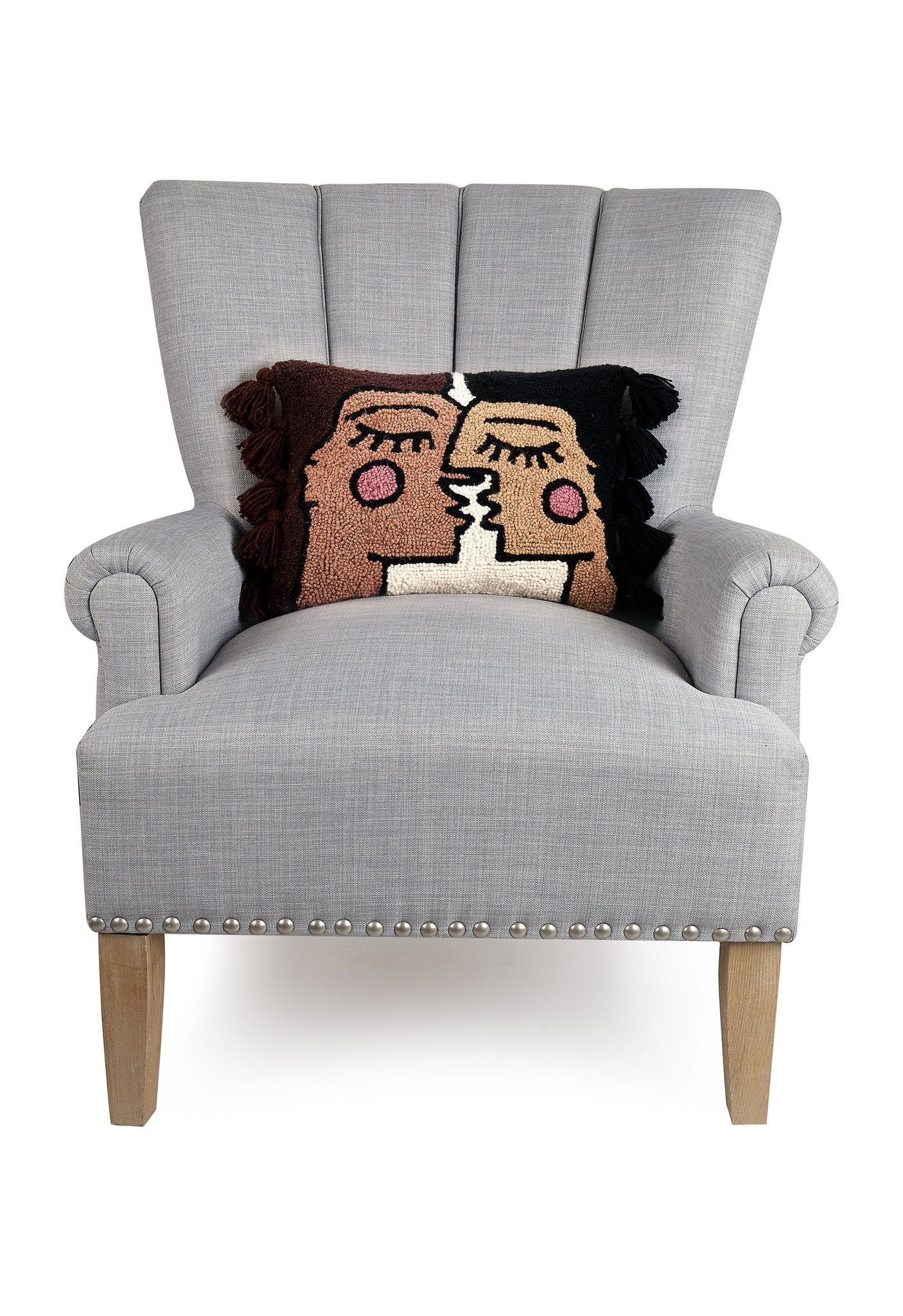 Bacio with Tassels Hooked Wool Throw Pillow on an armchair, showing the throw pillow at room scale, 12x16 inch