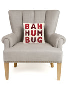 Bah Humbug Hooked Wool Christmas Throw Pillow on an armchair, showing the throw pillow at room scale, 10x10 inch