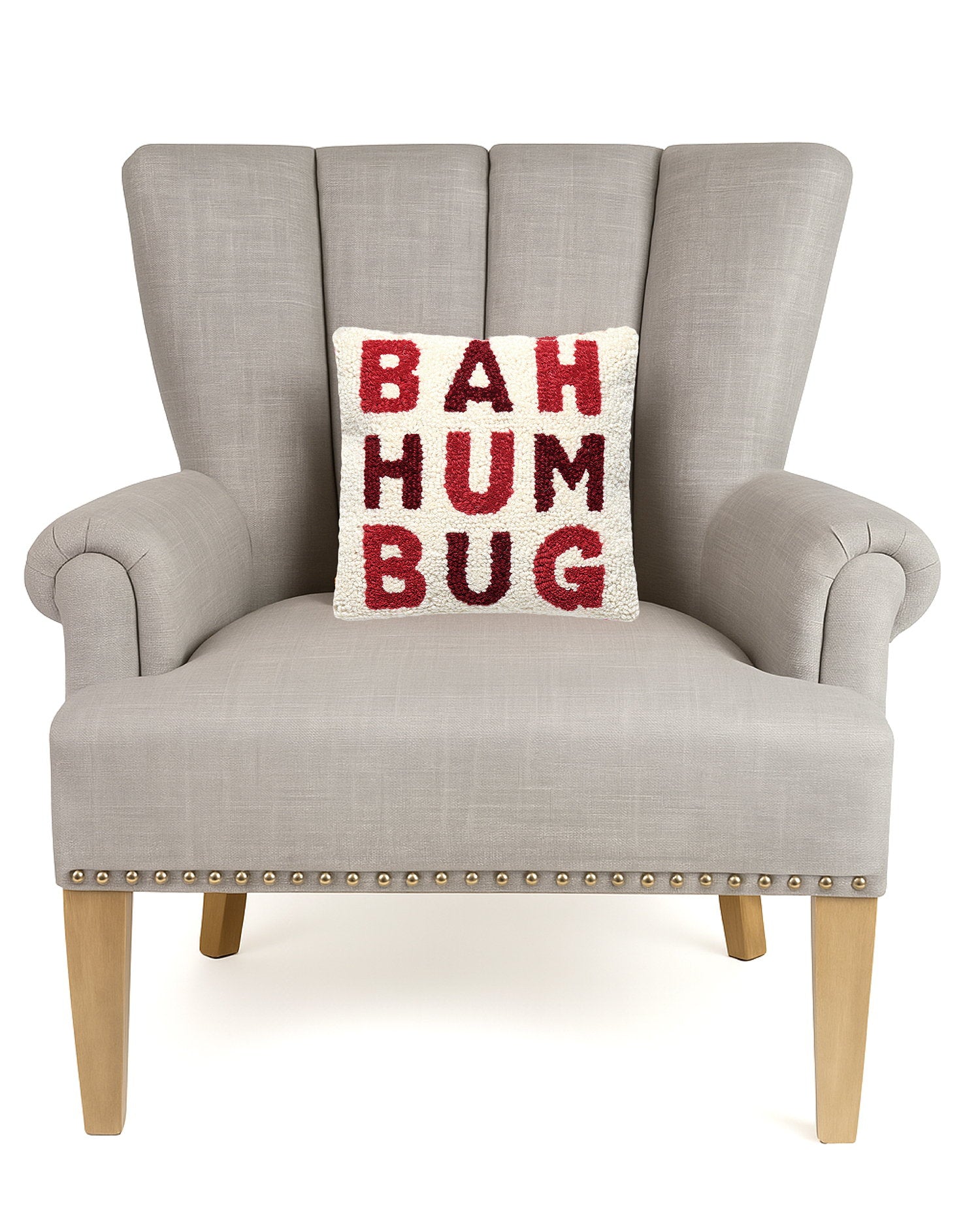 Bah Humbug Hooked Wool Christmas Throw Pillow on an armchair, showing the throw pillow at room scale, 10x10 inch