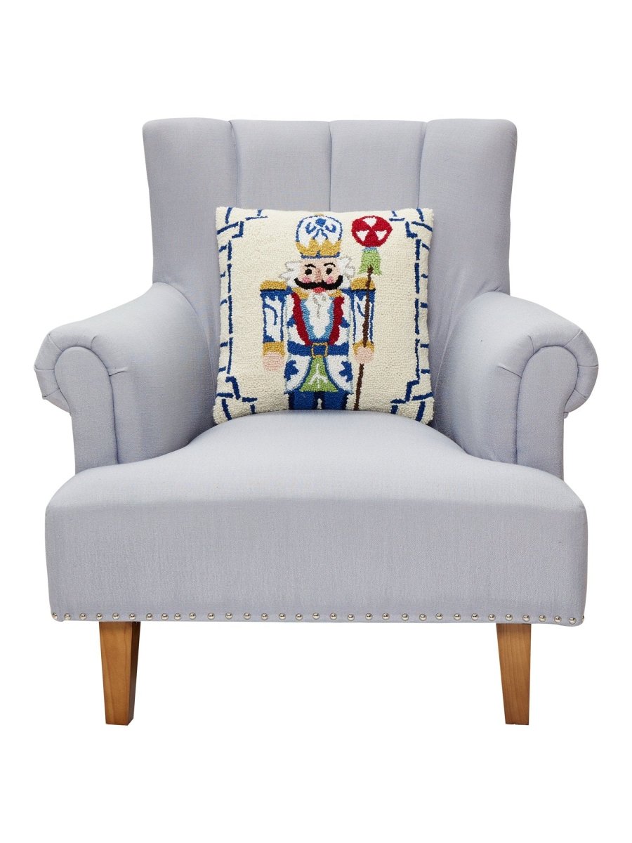 Bamboo Chinoiserie Nutcracker Hooked Wool Christmas Throw Pillow on an armchair, showing the throw pillow at room scale, 16x16 inch
