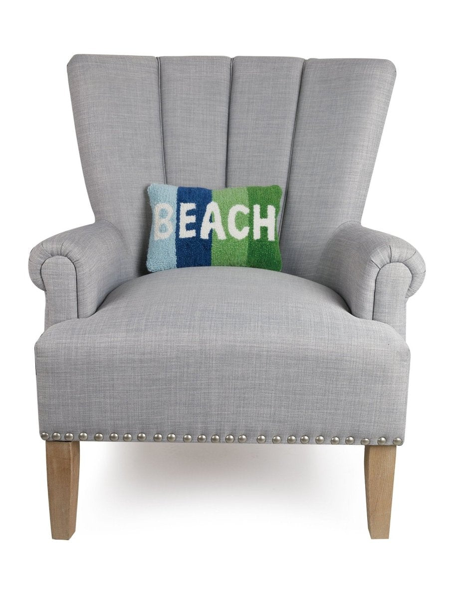 Beach Hooked Wool Throw Pillow on an armchair, showing the throw pillow at room scale, 8x12 inch