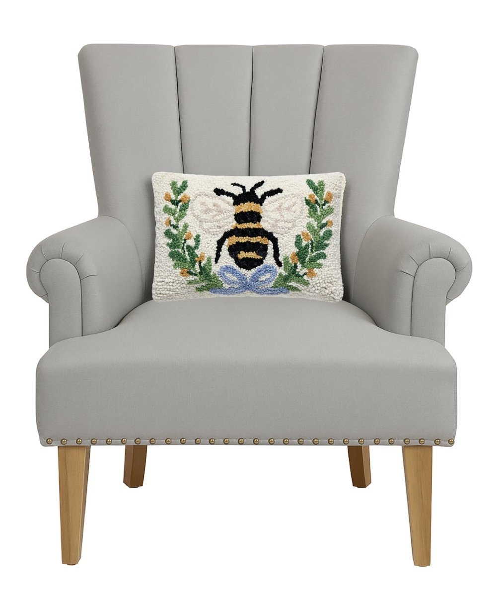 Bee in a Wreath Hooked Wool Throw Pillow on an armchair, showing the throw pillow at room scale, 8x12 inch