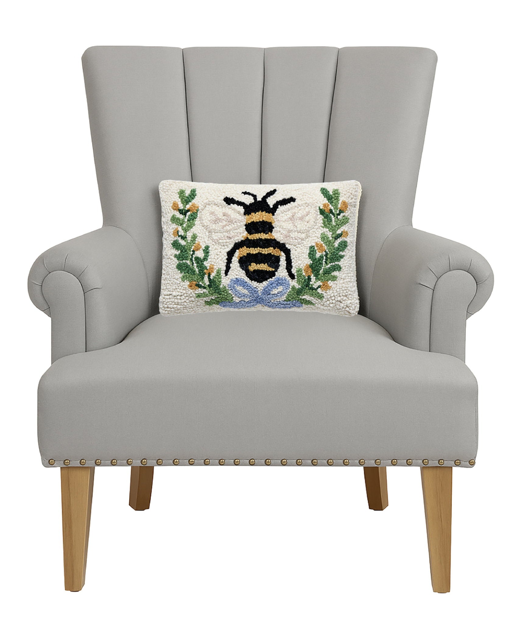 Bee in a Wreath Hooked Wool Throw Pillow on an armchair, showing the throw pillow at room scale, 8x12 inch