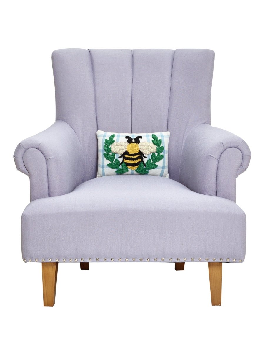 Bee Wreath Hooked Wool Throw Pillow on an armchair, showing the throw pillow at room scale, 8x12 inch