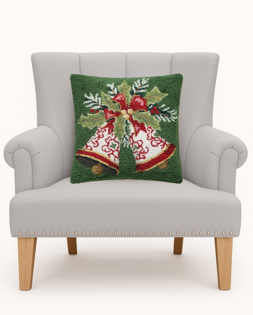 Bells Hooked Wool Christmas Throw Pillow on an armchair, showing the throw pillow at room scale, 16x16 inch