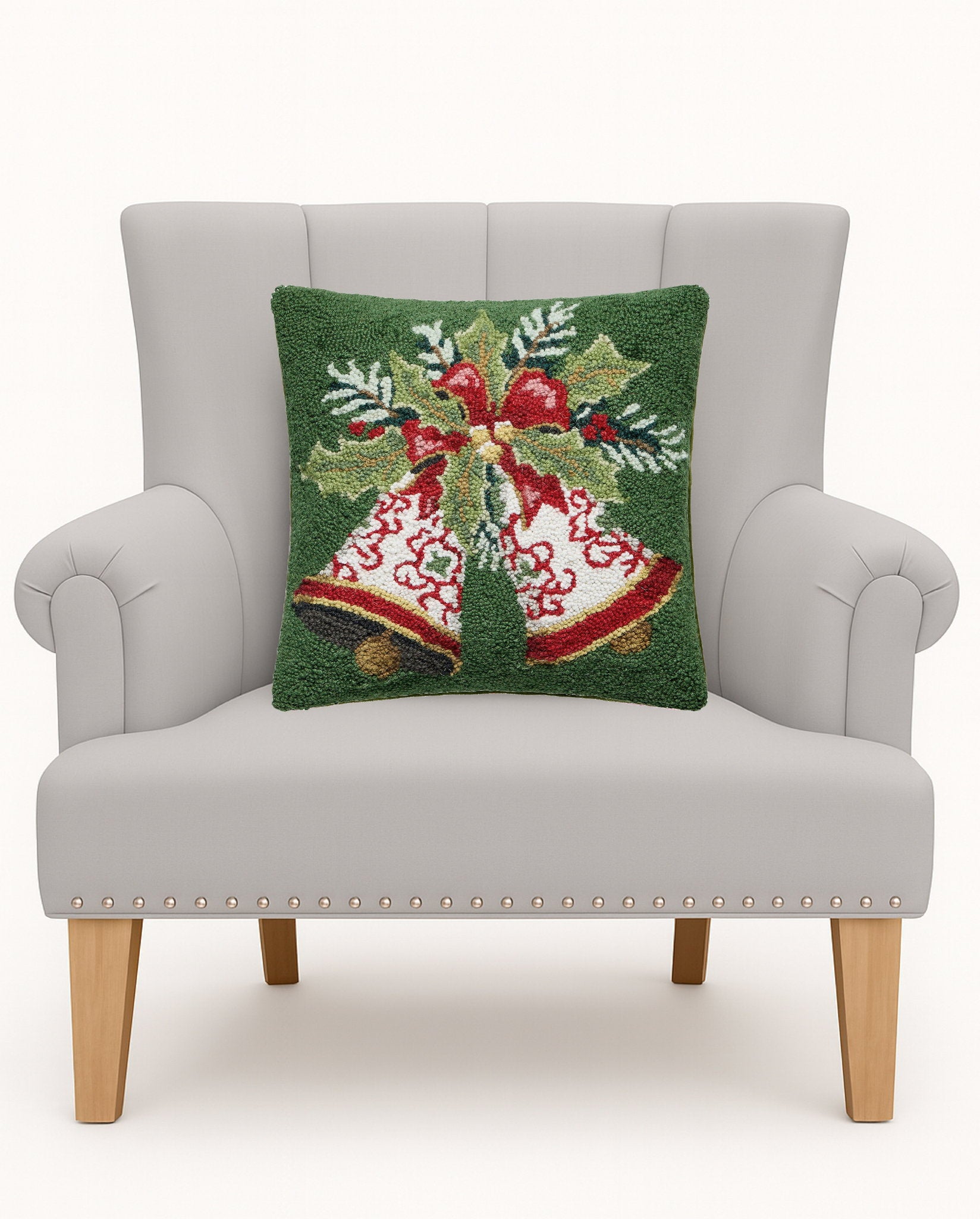 Bells Hooked Wool Christmas Throw Pillow on an armchair, showing the throw pillow at room scale, 16x16 inch