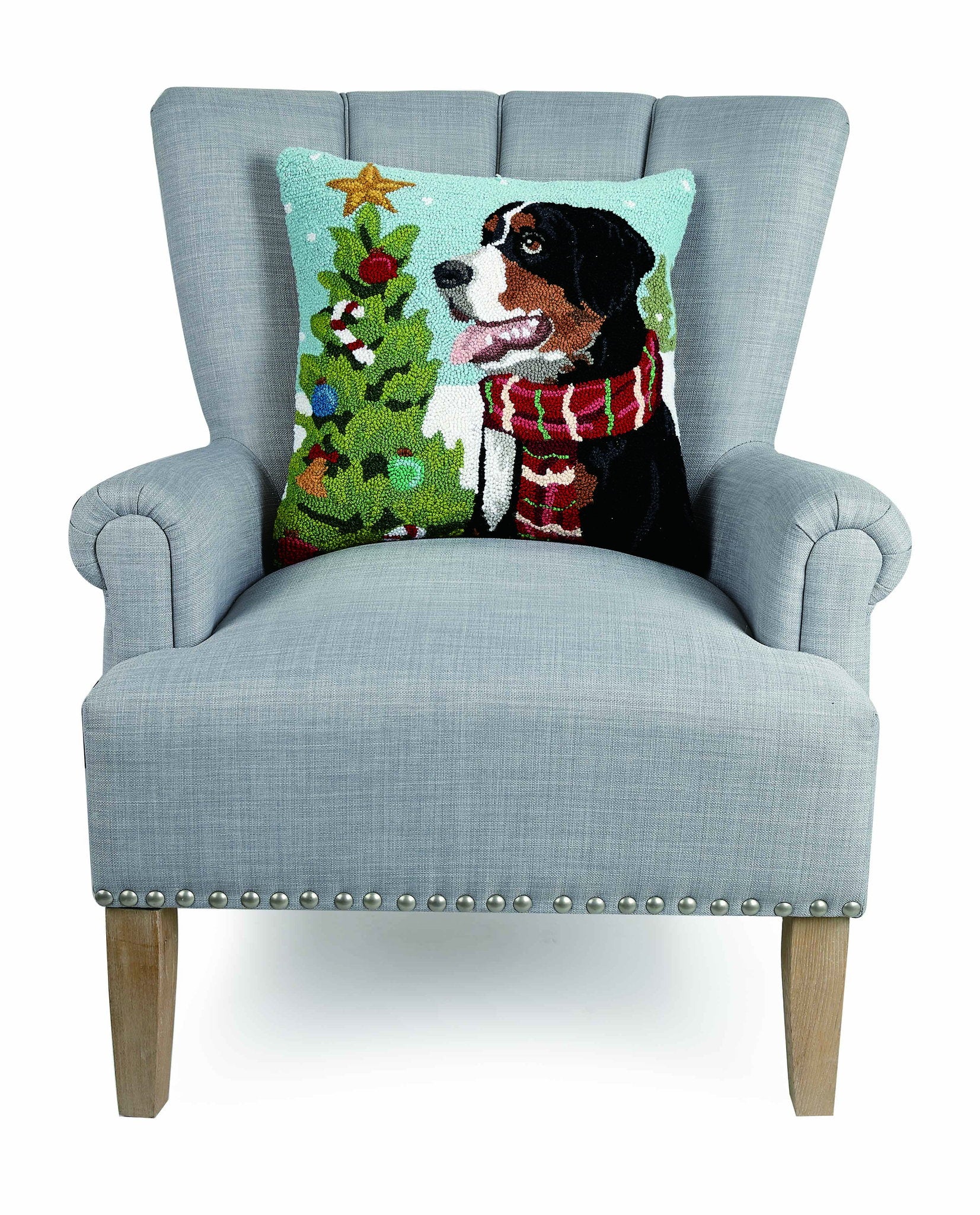 Bernese Mountain Dog Hooked Wool Christmas Throw Pillow on an armchair, showing the throw pillow at room scale, 18x18 inch