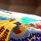 Big Sur Coastal Cliffs Embroidered Travel Throw Pillow - close-up detail of hand-embroidered needlepoint stitching