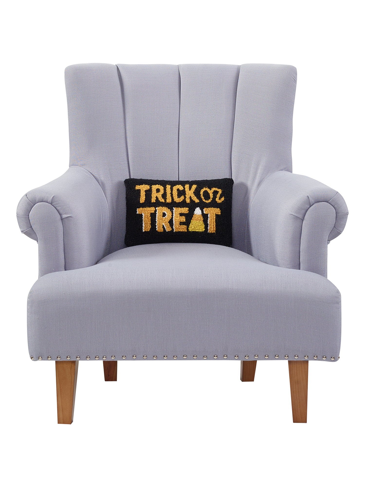 Black and Gold Trick or Treat Hooked Wool Halloween Throw Pillow on an armchair, showing the throw pillow at room scale, 8x12 inch