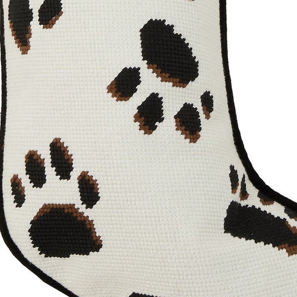 Closeup of Black Paws on White Embroidered Christmas Stocking showing stitch texture and craftsmanship detail