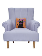 Black Witch Cat Hooked Wool Halloween Throw Pillow on an armchair, showing the throw pillow at room scale, 10x10 inch