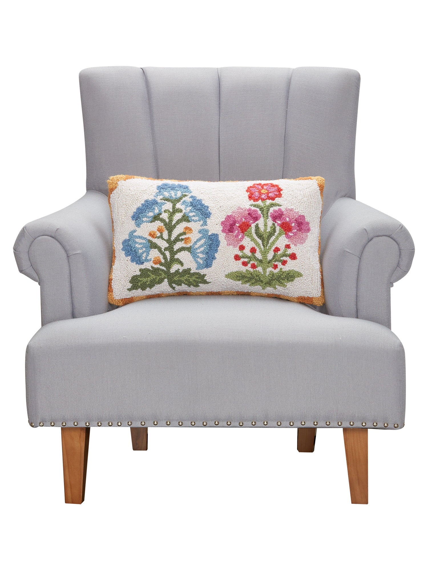 Blue and Magenta Mughal Flower Hooked Wool Throw Pillow on an armchair, showing the throw pillow at room scale, 12x20 inch