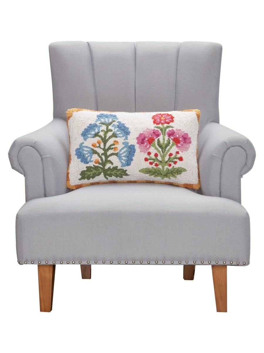 Blue and Magenta Mughal Flower Hooked Wool Throw Pillow on an armchair, showing the throw pillow at room scale, 12x20 inch