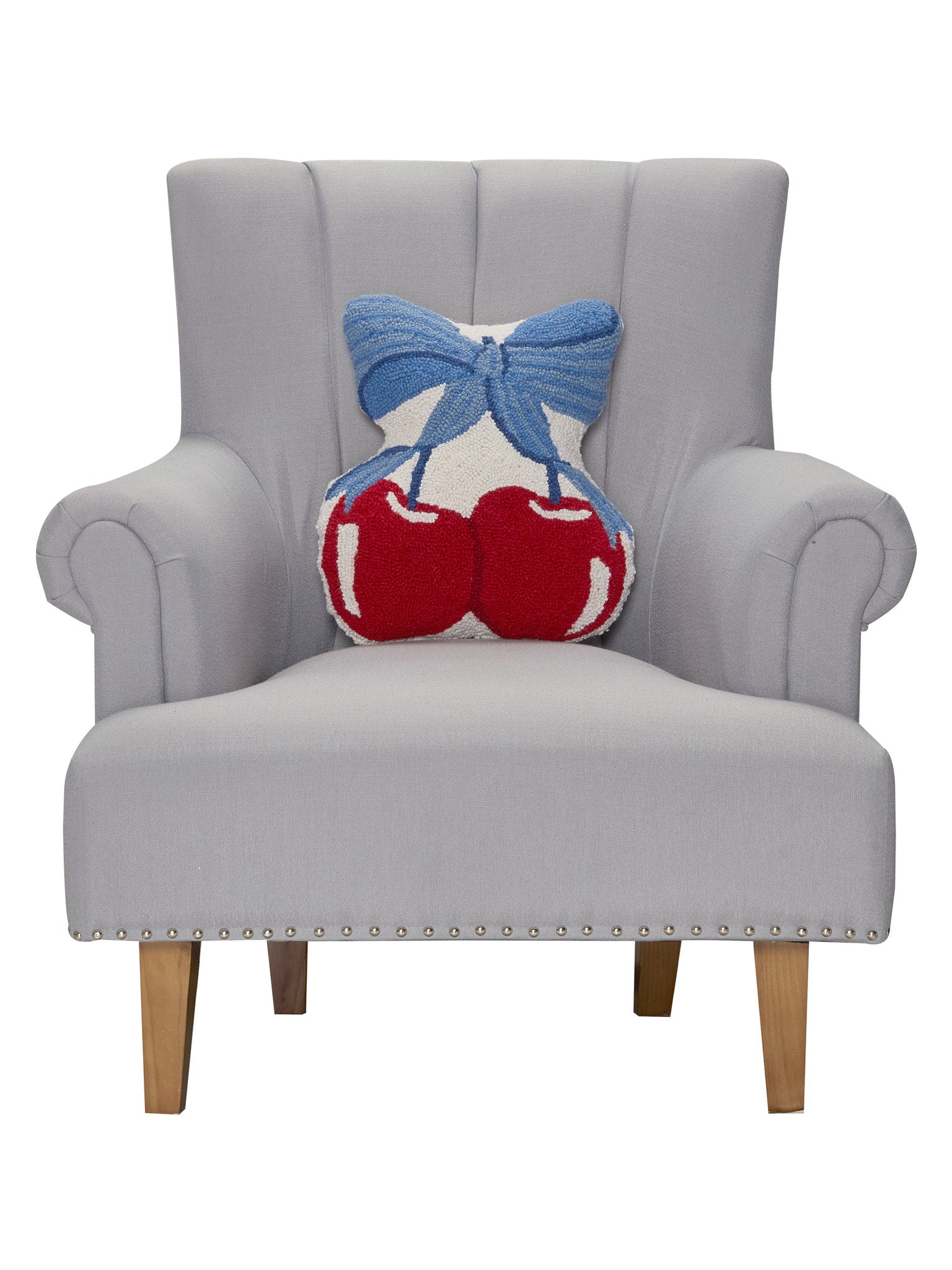 Blue Bow Shaped Cherries Hooked Wool Throw Pillow on an armchair, showing the throw pillow at room scale, 14x16 inch