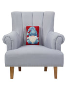 Blue Gnome Hooked Wool Christmas Throw Pillow on an armchair, showing the throw pillow at room scale, 8x12 inch