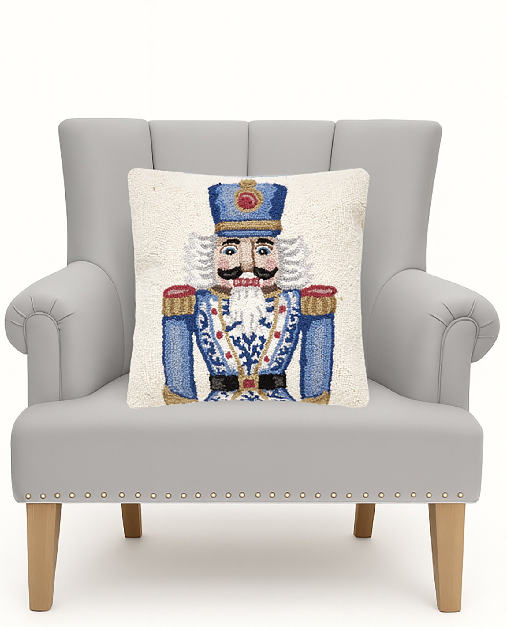 Blue Gold Chinoiserie Nutcracker Hooked Wool Christmas Throw Pillow on an armchair, showing the throw pillow at room scale, 18x18 inch