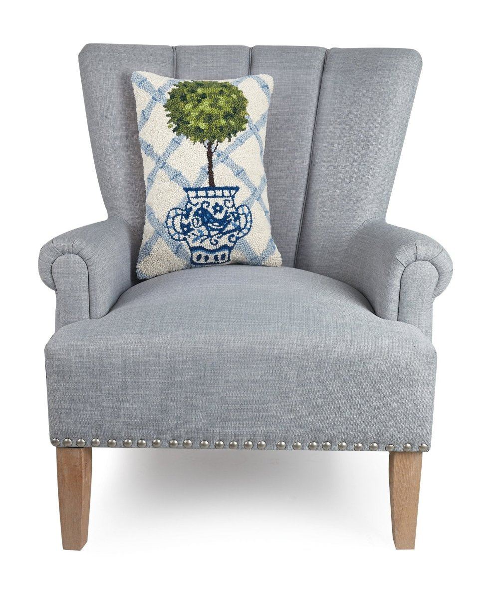 Blue Lattice Ball Topiary Hooked Wool Throw Pillow on an armchair, showing the throw pillow at room scale, 12x18 inch